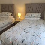 Twin bedroom in a Brooklands cottage apartment with two single beds made up