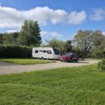 Touring caravan pitched at Brooklands beside the fishing lake